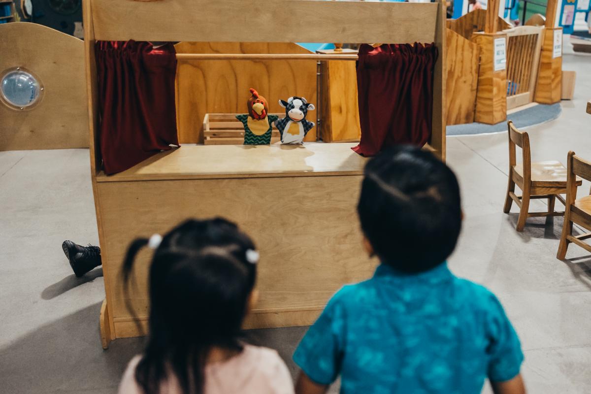 Child at SDCDM watching puppet theater
