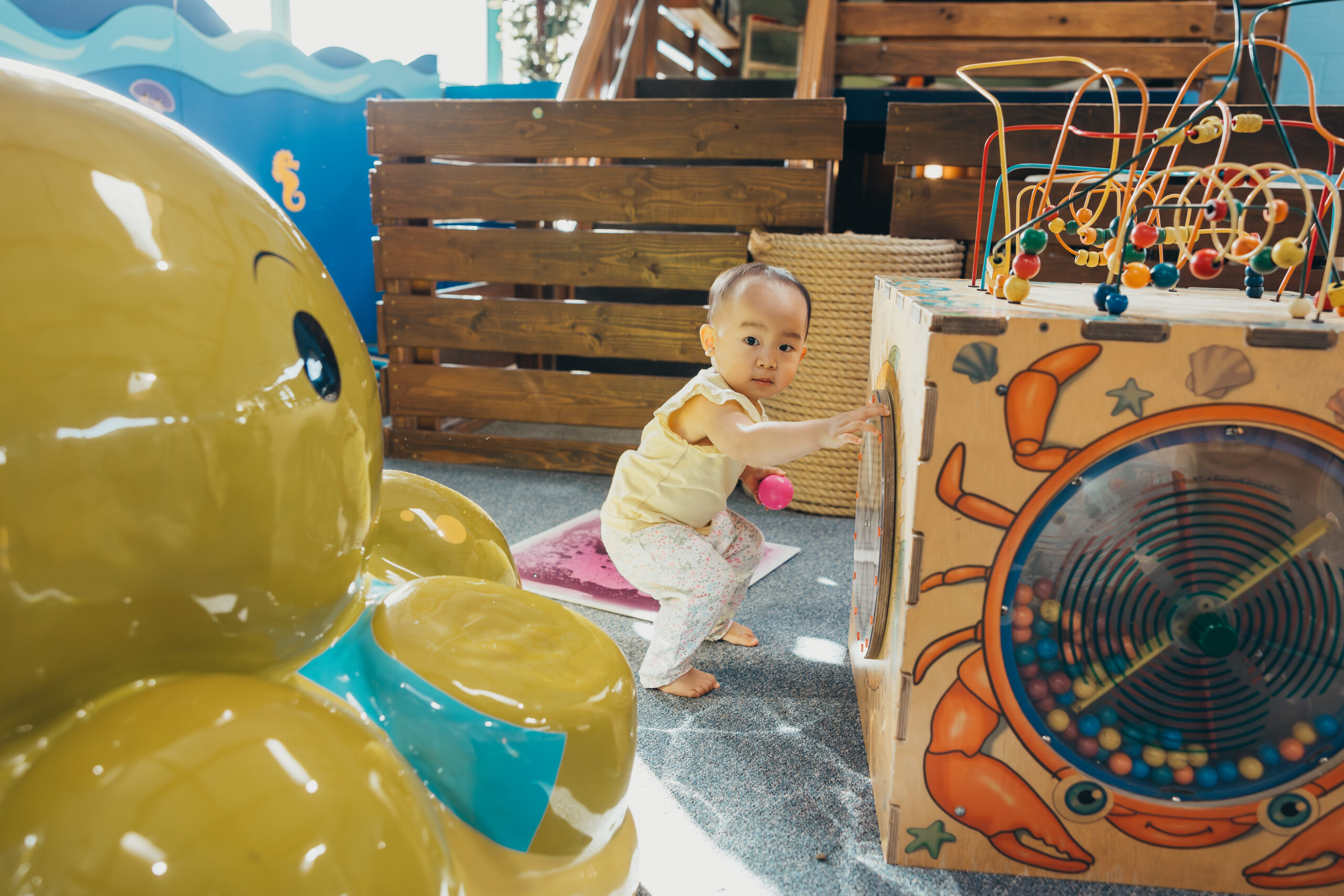 Toddler at SDCDM playing next to octopus statue