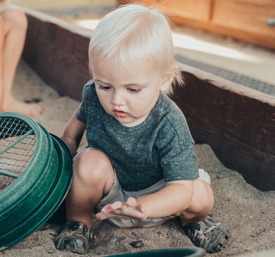 Child at SDCDM playing in sandbox