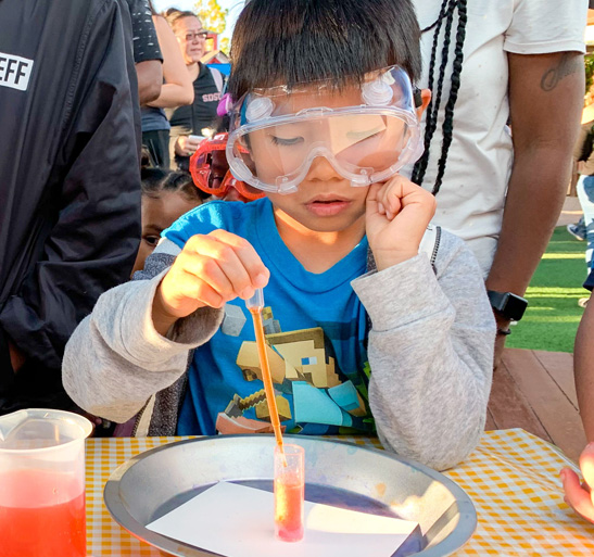Child at SDCDM doing science experiment
