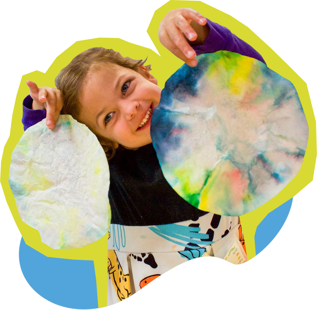 pressroom-kid Child holding their art up for display on paper and smiling