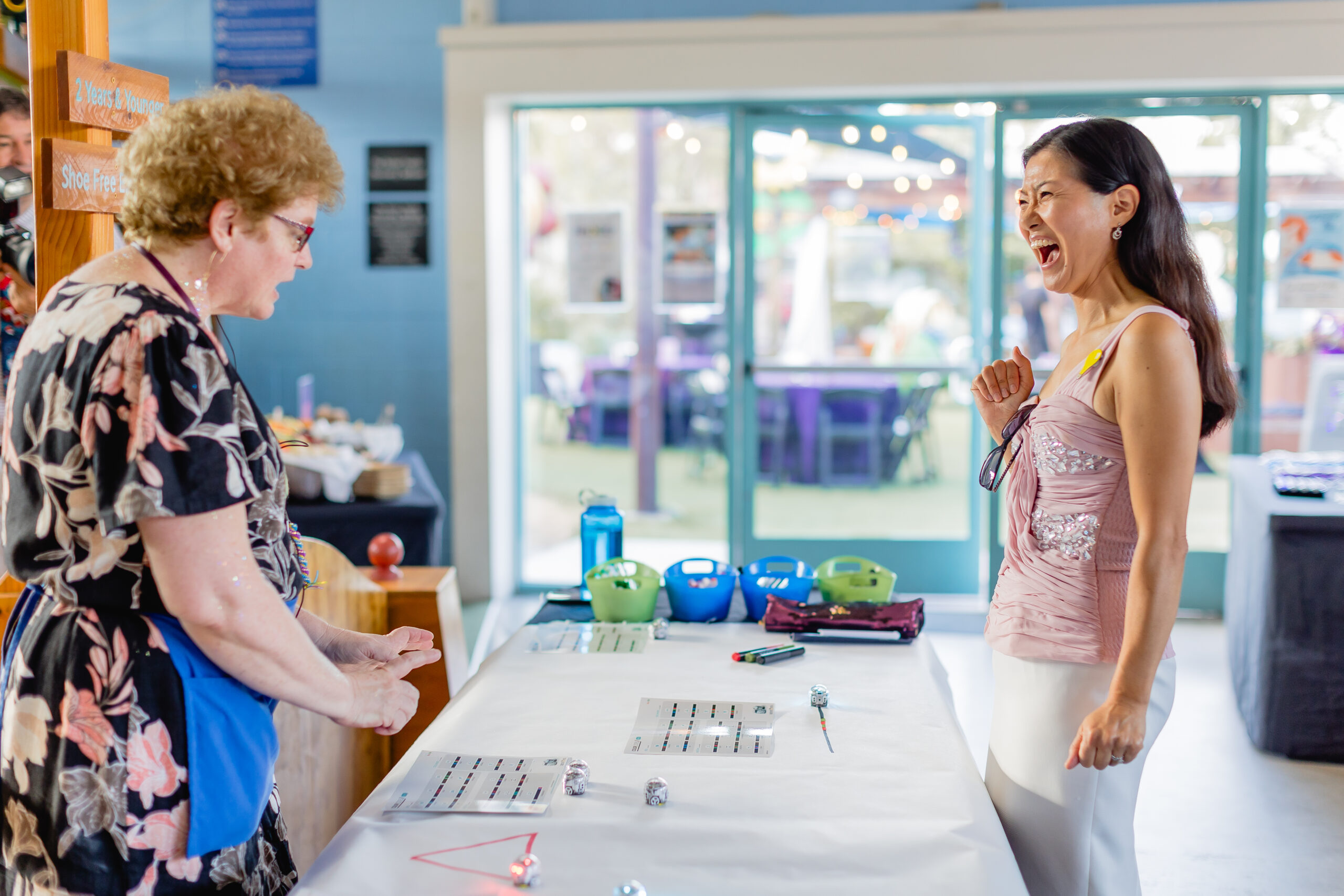 Two women playing with ozobot robots