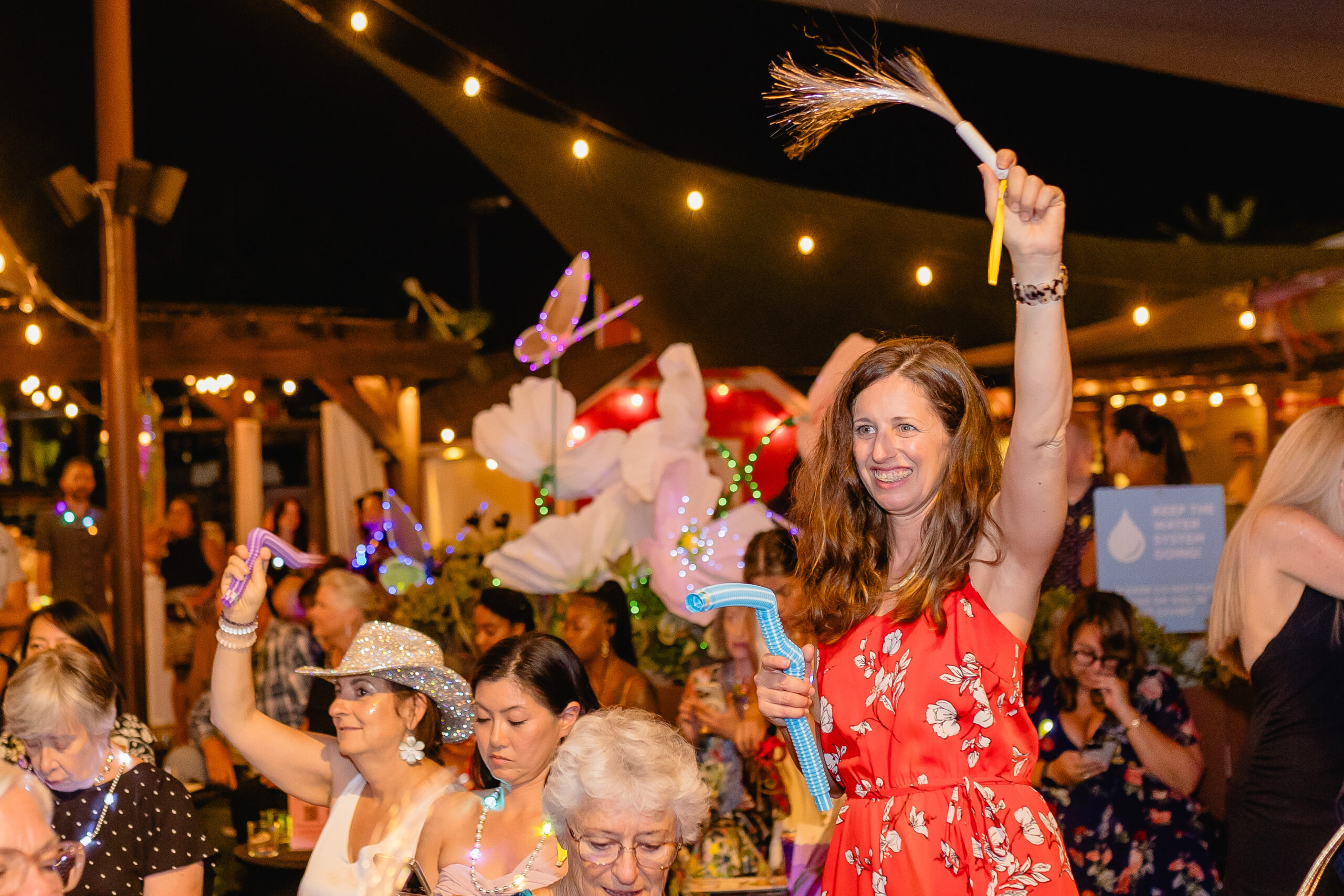 Woman waving glow stick in the air