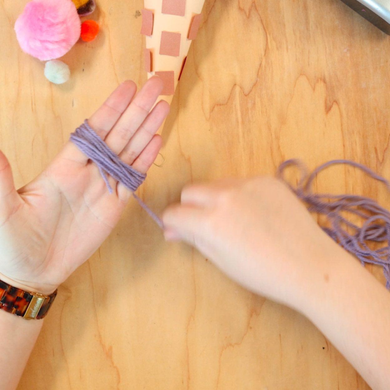 Wrap yarn around hand