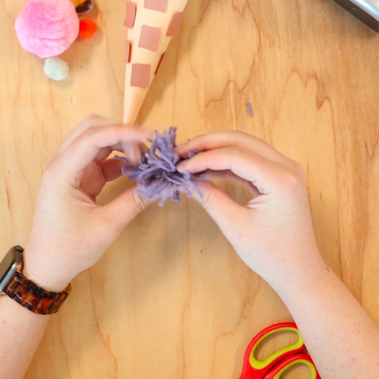 Cut edges of pom pom