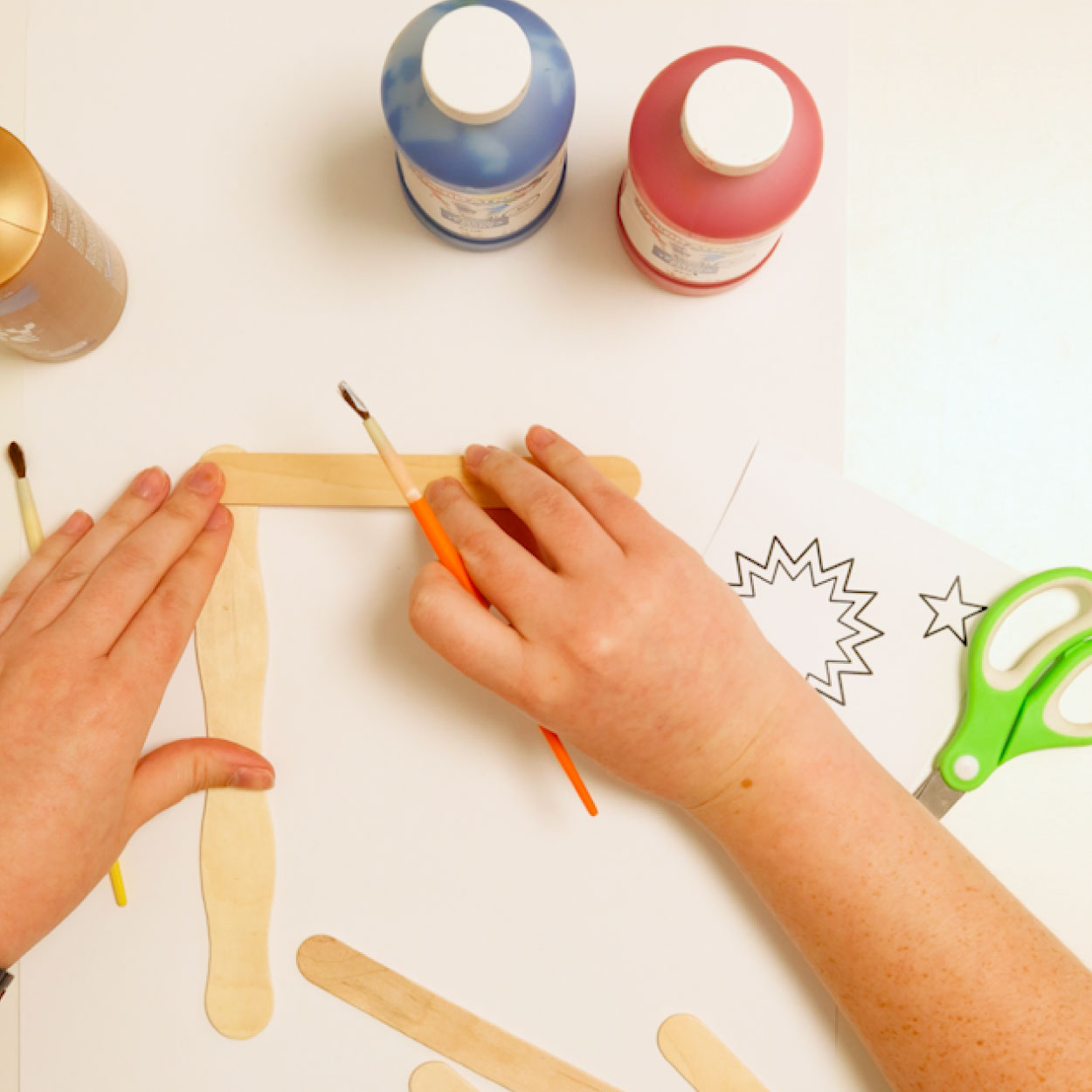 Glue five popsicle sticks horizontally onto a tongue depressor to build the base of a Juneteenth flag craft